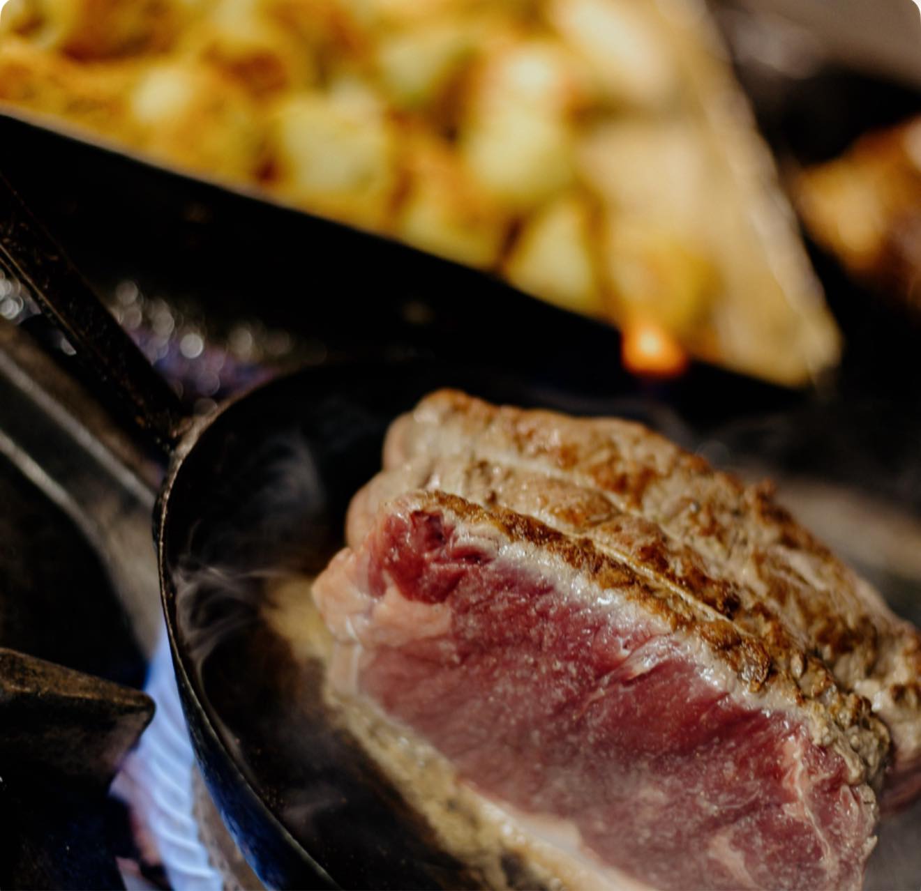 Sizzling steak in cast iron skillet