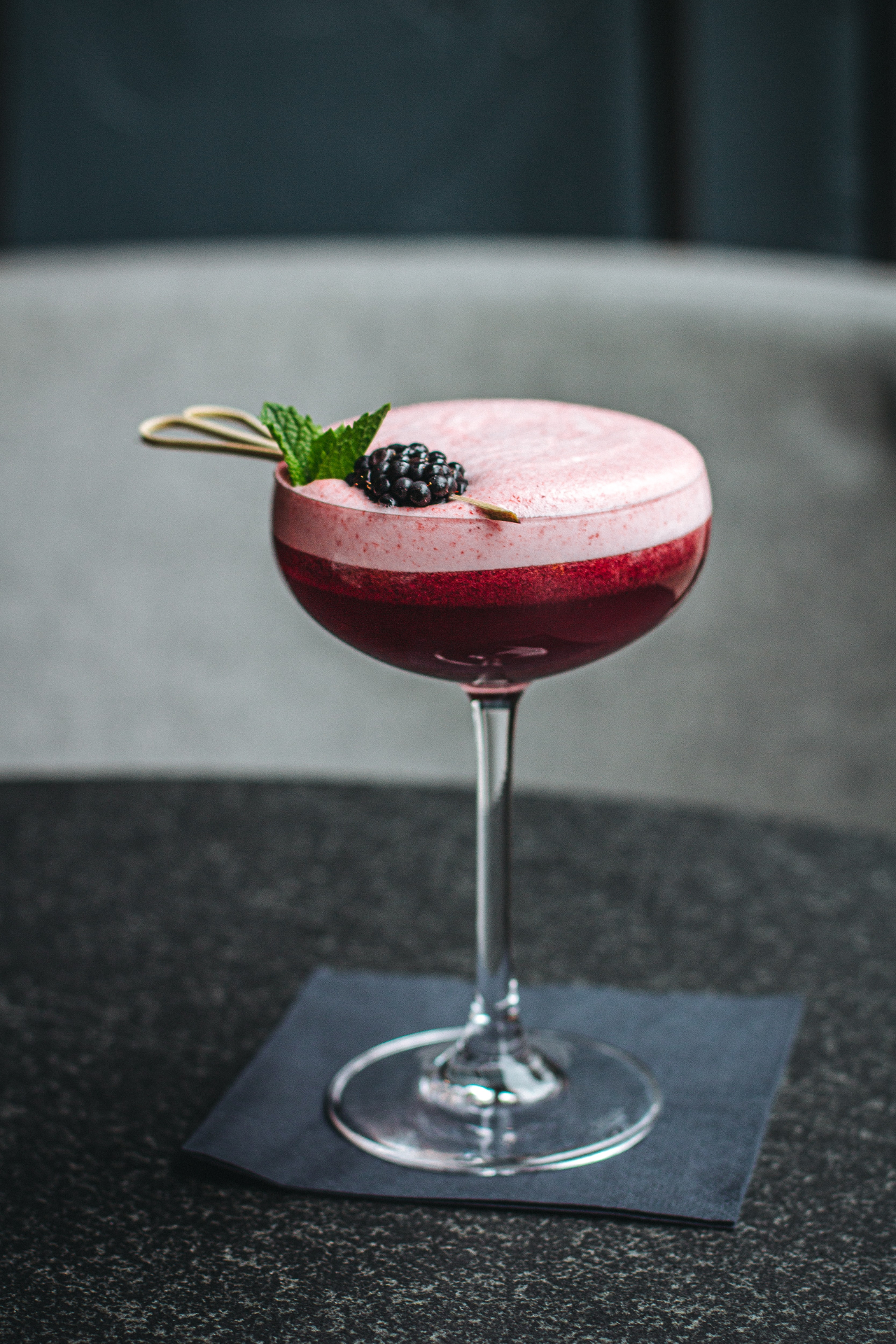 Blackberry sour cocktail with mint garnish